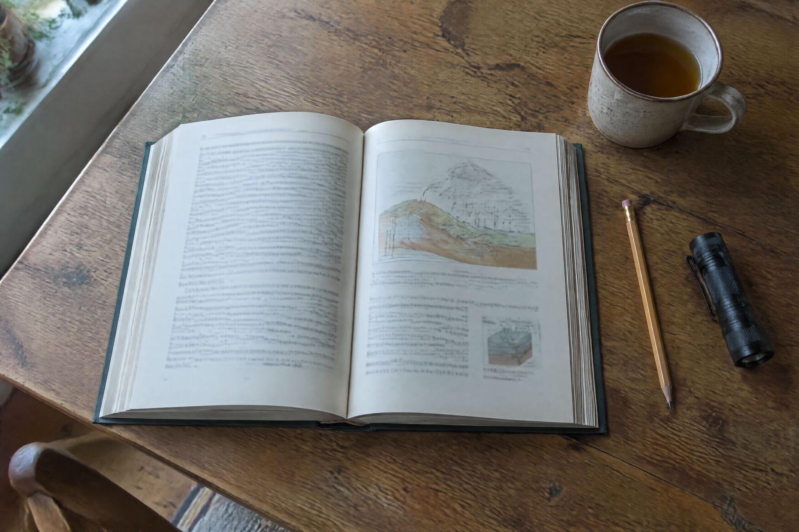 The Old British House Manual open on a kitchen table